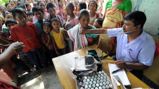 doctor treating a patient in a rural village school