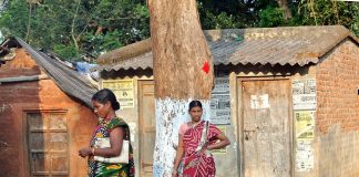 Tribal women from Odisha standing on the roadside.