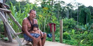 An indigenous man and child featured in the documentary. Image by Michael Clark/Gravitas Ventures.